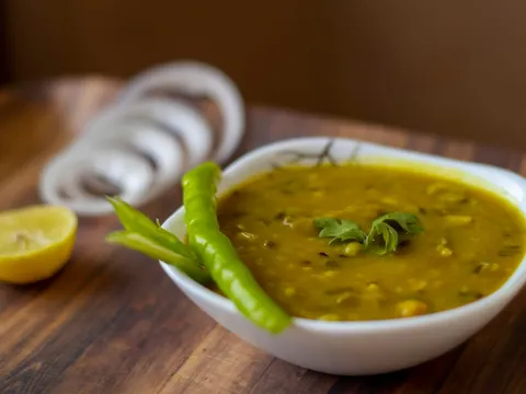 A bowl of yellow dal tadka with a tempering on top