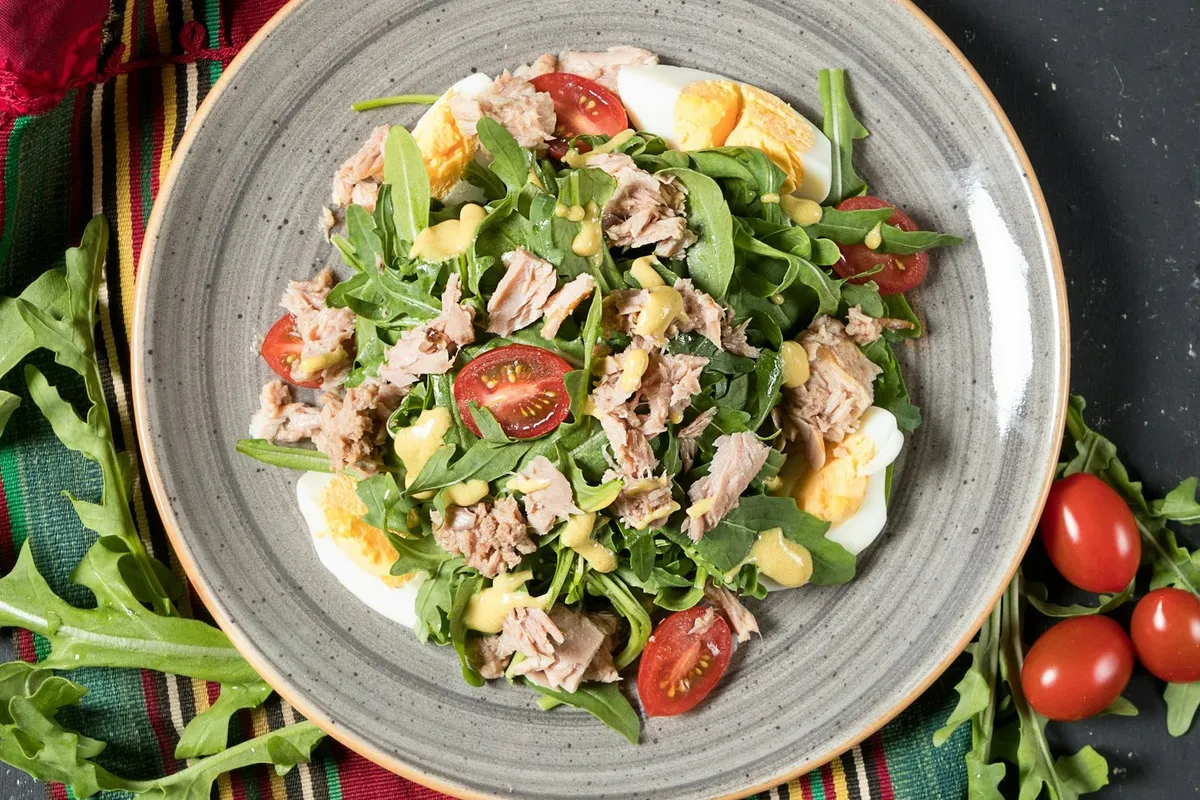 Grilled chicken strips over a salad of greens and vegetables