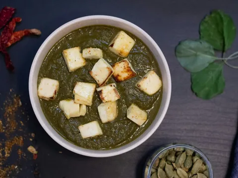 Palak paneer with cubes of paneer in a spinach gravy