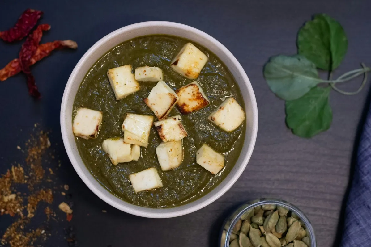 Palak paneer with cubes of paneer in a spinach gravy