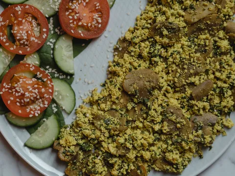 Scrambled tofu bhurji with onion and tomato in a pan